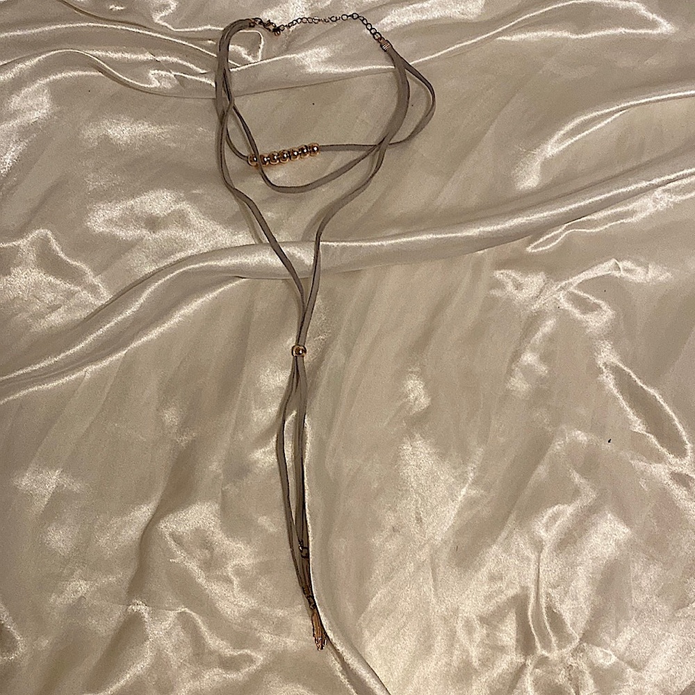 Layered grey choker necklace with feather charms